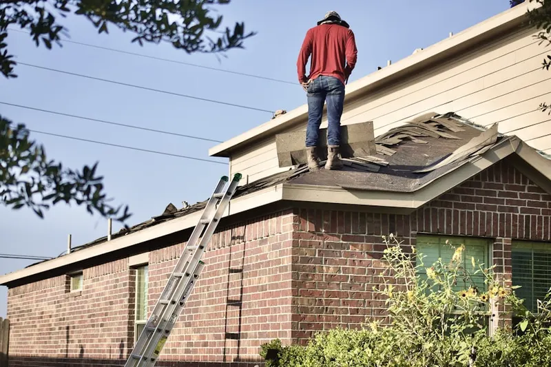 Professional roofer working on a residential roof in Gilliam Meadows
